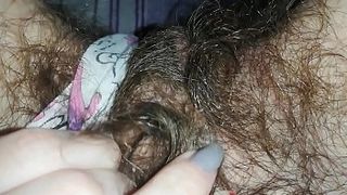 Amateur plays with her furry vagina in super closeup solo